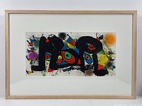 Full view of framed Joan Miro lithograph showing entire image, mat and frame