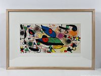 Full view of framed lithograph showing mat and light wood frame