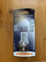 Sylvania SilverStar H7 ST halogen light bulb in retail packaging showing front with bulb visible and product information.