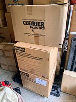 Three stacked cardboard moving/storage boxes