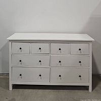 Front view of the white IKEA HEMNES 8-drawer dresser showing drawer configuration and black knobs.