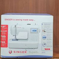Front of the boxed Singer Superb 2010 sewing machine highlighting features and branding.