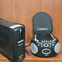 Lot including the Jensen CD540 portable stereo with top-loading CD and cassette recorder, and Bose headphones in carrying case on top