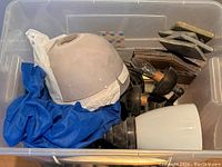 Three hardwired wall sconces with different glass globes and some miscellaneous slate tiles in container