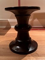 Front view of the chocolate brown side table/plant stand showing turned block style design and finish.