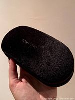 Photo of the closed chocolate brown velvet Tom Ford sunglasses case showing the textured exterior with 'TOM FORD' embossed on top