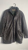Full view of men's Danier leather jacket in dark brown, hanging on a hanger, front view.