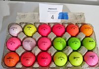 Photo of 18 assorted coloured golf balls in a carton tray showing multiple brands and used condition.