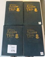 Top view of four hardcover 'Works of Alexandre Dumas' books arranged in a square showing their dark green covers with gold embossed title and author portrait from 1893 edition.