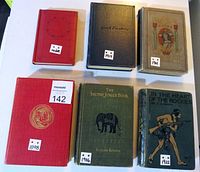 Six antique books in varying colors like red, green, and blue with publication years marked on front covers (1898, 1906, 1914, 1921)