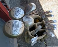 Top-down angle of golf clubs in the bag showing club head numbers and branding of woods