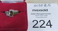 Ring displayed inside a red velvet jewelry box with maxsold auction tag showing size 8.5 and lot number 224