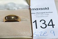 Men's gold-tone wedding band displayed in an open box showing size 9 note.