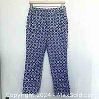 Front view of the Max Mara cropped pants hanging on a hanger, showing the dark blue and white geometric pattern.