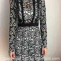 Front view of the Self-Portrait Antoinette floral guipure-lace dress showing long sheer sleeves, fitted waist, floral lace details and high neckline.