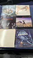Photo showing six vinyl record album covers including The Police, Pink Floyd, and a sci-fi themed soundtrack.