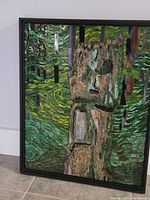 Framed mosaic artwork showing full composition of totem pole and forest background