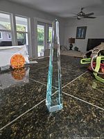Obelisk standing upright on granite counter showing size and shape