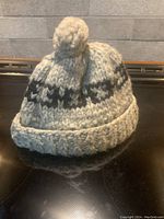 Front view of vintage 1960's Cowichan knit wool toque, showing pom pom and geometric band