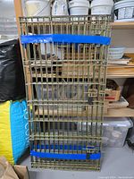 Front view showing metal wire panel with blue tape wrapped horizontally.