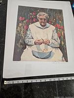 Full view of the print showing an elderly woman peeling vegetables with flowers around her, includes a measuring tape showing approximate size.