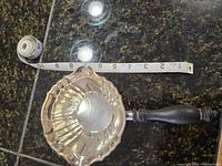 Top view of the polished sterling silver sauce pot with fluted design showing approximate measurement.