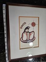 Full view of framed print with measuring tape alongside showing size approximately 13.5 inches height