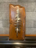 Front view of the wood plaque with metal tree inlay showing size and condition.