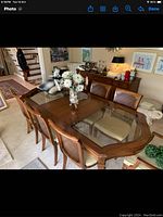 Full view of dining table with glass inserts and seven cane-back chairs