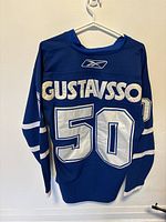 Back view of the blue Toronto Maple Leafs Reebok jersey showing 'GUSTAVSSON' and number '50'.