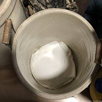 Top interior view of the crock showing the inside surface and papers.