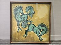 Front view of framed silk painting showing two horses in greenish blue on golden background