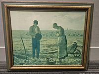 Front view of framed Millet Angelus Series print showing two farmers in field bowing heads in thanks.