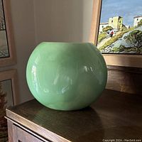 Haeger vintage orb vase in Caledon green, front view showing round shape and glaze.