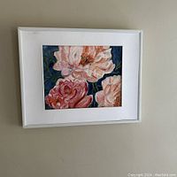 Framed original oil painting of white and pink peonies on paper, hanging on a wall.