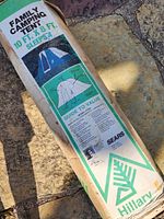 Photo of tent in original packaging with label detailing dimensions and model information.