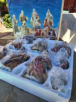 Christmas nativity figurines still in molded tray with box showing assembled figurines in outdoor setting.