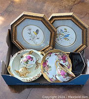 Lot items including two framed octagonal bird prints, porcelain tea set pieces with pink roses and gold trim, and a small black dish in a box.
