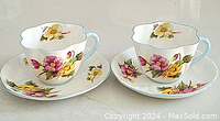 Image of two Shelley floral cups sitting on matching saucers, showing the full set.