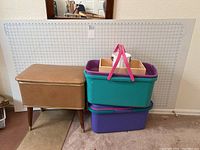 Photo shows large rectangular cutting mat behind sewing containers and wooden sewing box.