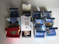 Top view photo showing all jewelry pieces in original Avon boxes including butterfly pins and brooches.