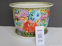 Front angled view of the large colorful Chinese ceramic planter showing full floral design and geometric border.