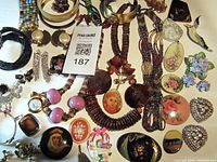 Full spread of the costume jewelry lot showing diverse pieces including necklaces, brooches, bracelets, and earrings.