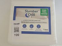 Photo of folded white Slumber Chill king size 6 piece cooling sheet set showing packaging label with brand and features.