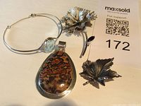 Photo showing the entire set of vintage sterling silver jewelry including the pendant, necklace, and three pins.