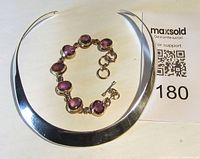 Collar necklace and amethyst stone bracelet laid flat showing full design and toggle clasp on bracelet