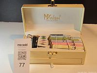 Overall view of My Wish Collezioni watch set in cream-colored box with watch, interchangeable straps, and clasp pieces neatly arranged inside