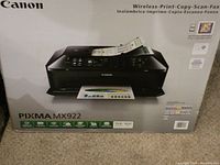 Canon Pixma MX922 box showing wireless print, copy, scan, fax functions and key features.