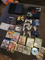 Lot overview with consoles, controllers and games