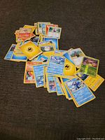 Photo showing a pile of assorted Pokemon trading cards including energy cards and Pokemon character cards.